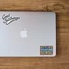 Small cropped view of laptop with Maurice's sticker.