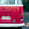 Cropped view of red bus with decal.