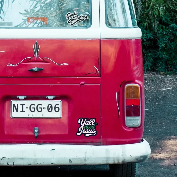 Cropped view of red bus with decal.