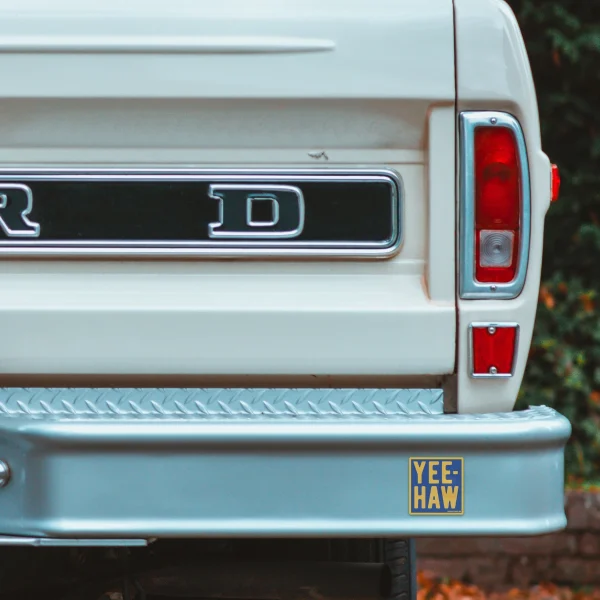 Small cropped view of pickup truck with decal.